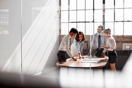 A team of business people is reviewing documents for a financial statement audit.